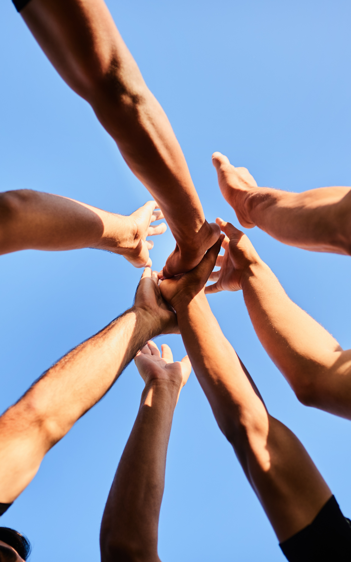 sports team hands held together in center of circle